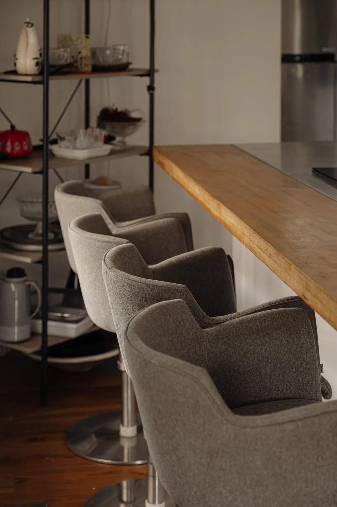 Breakfast bar with upholstered stools along a wooden counter in the kitchen