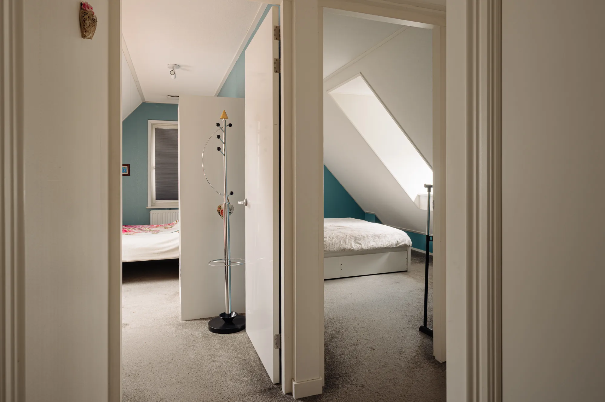 Upper hallway with open doors leading to two bedrooms